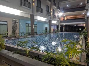 a large swimming pool in the middle of a building at HP Temasek Hotel in Malacca
