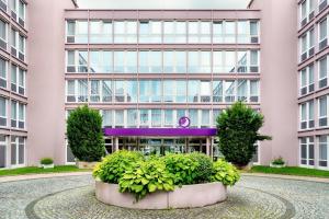 a large pink building with plants in front of it at Premier Inn München City Ost in Munich
