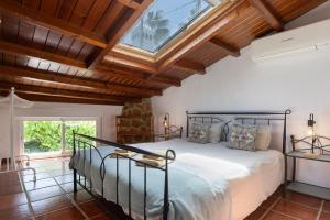 a bedroom with a bed and a vaulted ceiling at La Granja de Antonio in Alhaurín el Grande +175 photos