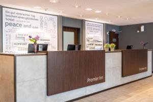 a reception counter in a lobby with a reception desk at Premier Inn München Airport Ost in Oberding