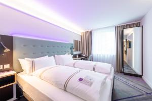 a hotel room with two beds and a mirror at Premier Inn München Airport Ost in Oberding +16 photos