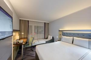 a hotel room with a bed and a flat screen tv at Premier Inn Stuttgart Airport Messe in Leinfelden-Echterdingen +16 photos