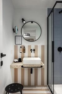 a bathroom with a sink and a mirror at Valesmeralda Boutique Rooms, Porto Cervo Marina Adults only in Porto Cervo +59 photos