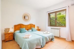 a bedroom with a bed and a window at Villa Cal Peso in Port de Pollensa +24 photos