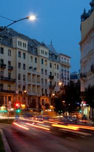 a city street at night with buildings and cars at Budapest Panorama Central in Budapest