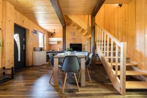 a kitchen and dining room with a table and stairs at Widokowa osada drewnianych domków, tuż przy szlakach turystycznych in Brenna +11 photos