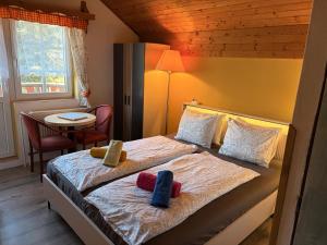 a hotel room with two beds and a table at Pension Eliška in Harrachov