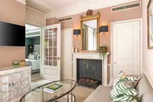 a living room with a fireplace and a mirror at The Royal Crescent Hotel & Spa in Bath