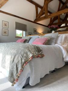a bedroom with a bed with a white comforter at The Silver Suite at Manor Farm in Edenbridge