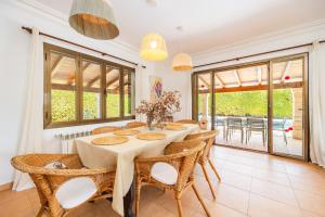 a dining room with a table and chairs at Villa Cal Peso in Port de Pollensa