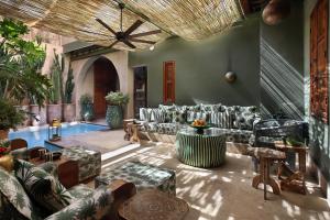 a living room with couches and a pool at El Fenn in Marrakesh