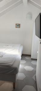 a room with two beds and a flat screen tv at CASA LUIGIA ROOMS MTB in FINALBORGO Bike room in Finale Ligure