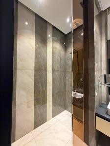 a glass shower in a bathroom with a sink at Sea Breeze Lighthouse 3 Studio ML in Nardaran