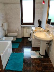 a bathroom with two sinks and two toilets at Casa Jesus - suite home in Almese