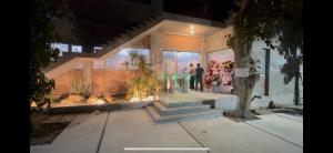 a man standing in front of a store at night at miniHomestay green view & warm pool - all apartment - 3 room - 6 persons - Ea Kar - Dak Lak in Buôn Mhang