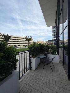 a patio with a table and chairs on a balcony at Sea Breeze Lighthouse 3 Studio ML in Nardaran