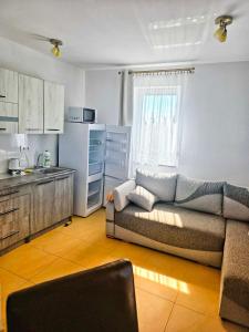 a living room with a couch and a kitchen at U Piotra in Sarbinowo