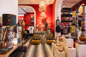 a store with red walls and yellow chairs in a store at El Fenn in Marrakesh +163 photos