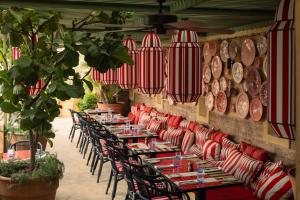 a row of tables in a restaurant with red and white stripes at El Fenn in Marrakesh