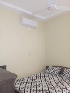 a bedroom with a bed with a ceiling at Unique in Ouagadougou