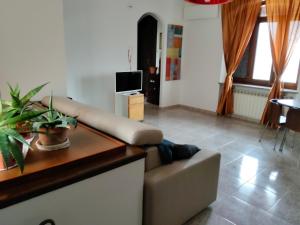 a living room with a couch and a tv at Casa Jesus - suite home in Almese