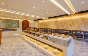 a buffet line in a restaurant with tables and chairs at The Forest Chapter by Sayaji Sasan Gir in Chitrod +93 photos