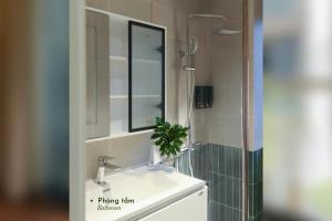a bathroom with a sink with a mirror and a shower at Well-being Home - Self-Service in Hanoi +48 photos