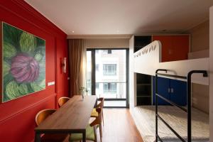 a dining room with a wooden table and a painting on the wall at Well-being Home - Self-Service in Hanoi
