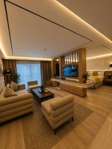 a large living room with couches and a tv at L'ADRESSE Boutique Hôtel & SPA Tanger in Tangier