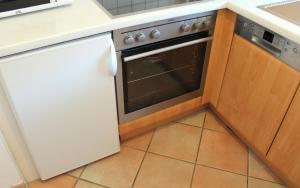 a kitchen with an oven and a tile floor at Ferienwohnung Weingärtner in Oberstdorf