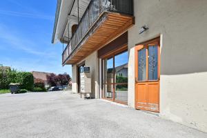a building with a wooden door on a street at Studio 42m² Design in Annecy