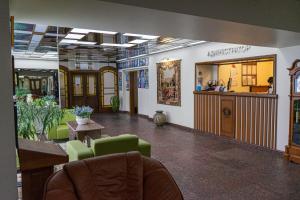 a waiting room with green chairs and a counter at Evropeyskiy in Kremenchuk +40 photos
