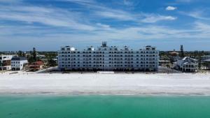 a large white building on the beach next to the ocean at Sunset Chateau 506 - Premier in St. Pete Beach