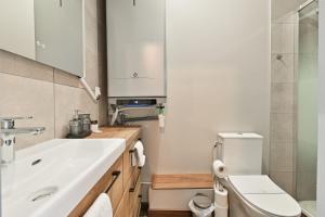 a bathroom with a sink and a toilet at Studio 42m² Design in Annecy +15 photos