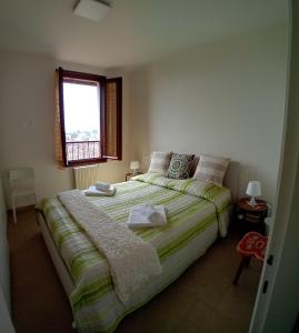 a bedroom with a large bed with a window at Maisonette Agata in Toscolano Maderno