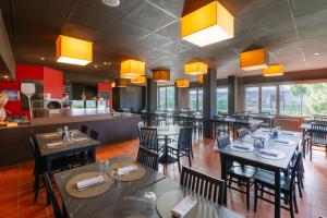 a dining room with tables and chairs in a restaurant at Smart Hotel King, by R Collection Hotels in Varedo