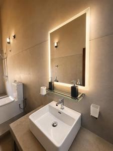 a bathroom with a sink and a mirror at CocoBaru - Private Beachfront Entire Villa in Marawila