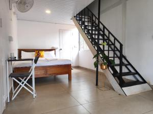 a bedroom with a bed and a spiral staircase at Rays of Bliss in Mananthavady +29 photos