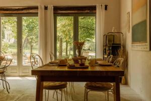 a dining room with a wooden table and chairs at Casa Ostara in Condorcet