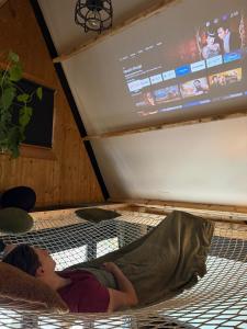 a young child laying on a bed in a room at Het Dubbele Punthuisje in Lanaken