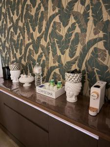 a counter with a coffee bar with pots on it at Elled-home in Misterbianco +51 photos