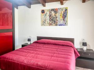 a bedroom with a red bed with two night stands at Casa Gli Allori in Iglesias