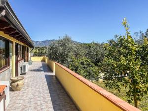 a walkway next to a house with trees at Casa Gli Allori in Iglesias