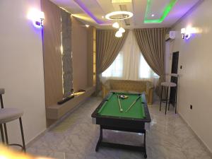 a living room with a pool table in a room at House 27 Alpha in Idu