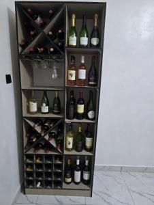 a refrigerator filled with lots of bottles of wine at House 27 Alpha in Idu +4 photos