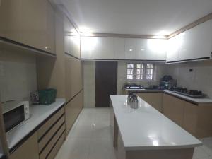 a kitchen with a sink and a microwave in it at House 27 Alpha in Idu