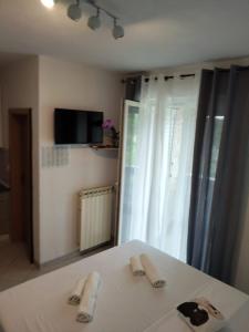 a bedroom with a bed with two slippers on it at Apartmani Mila-Casa Bianca in Medulin