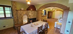 a dining room with a table and a fireplace at Poggio Cortese in Todi +59 photos