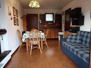 a living room with a table and chairs and a couch at Mountain Haven Free parking in Temù +8 photos