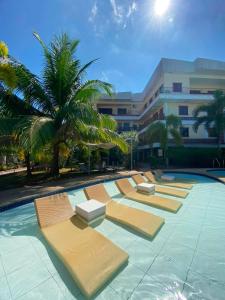a row of chaise lounges in a swimming pool at Sunville Hotel and Restaurant in Panglao Island